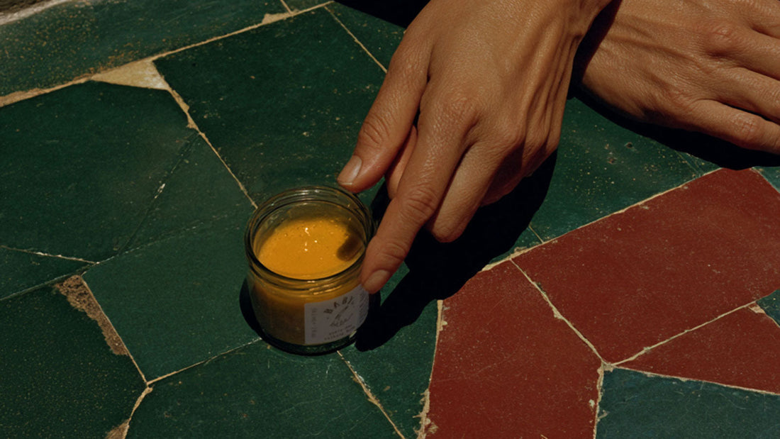 Person holding a jar of skin care balm