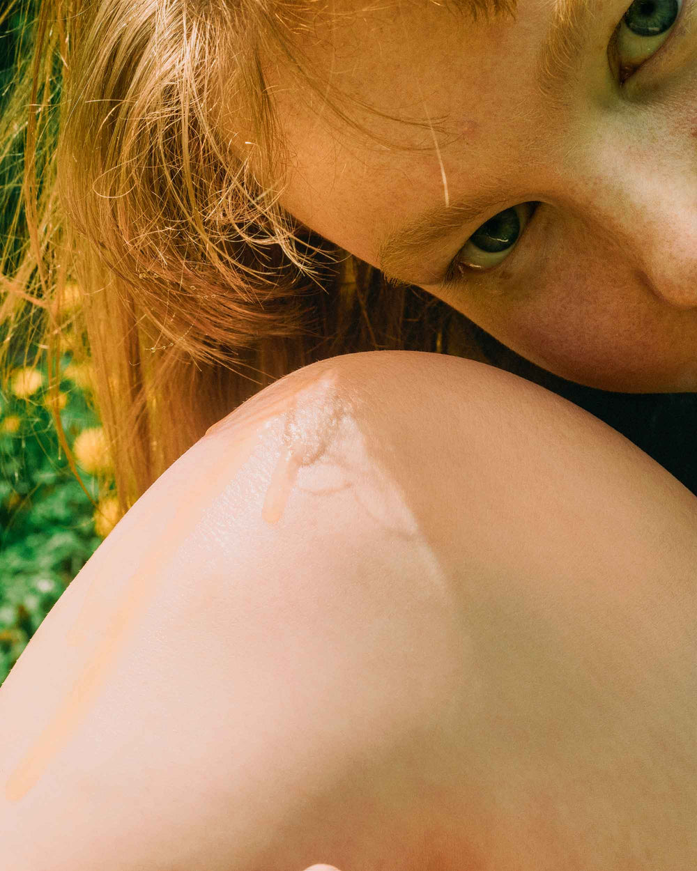 Photo of girl leaning her face on her knee showing her soft skin