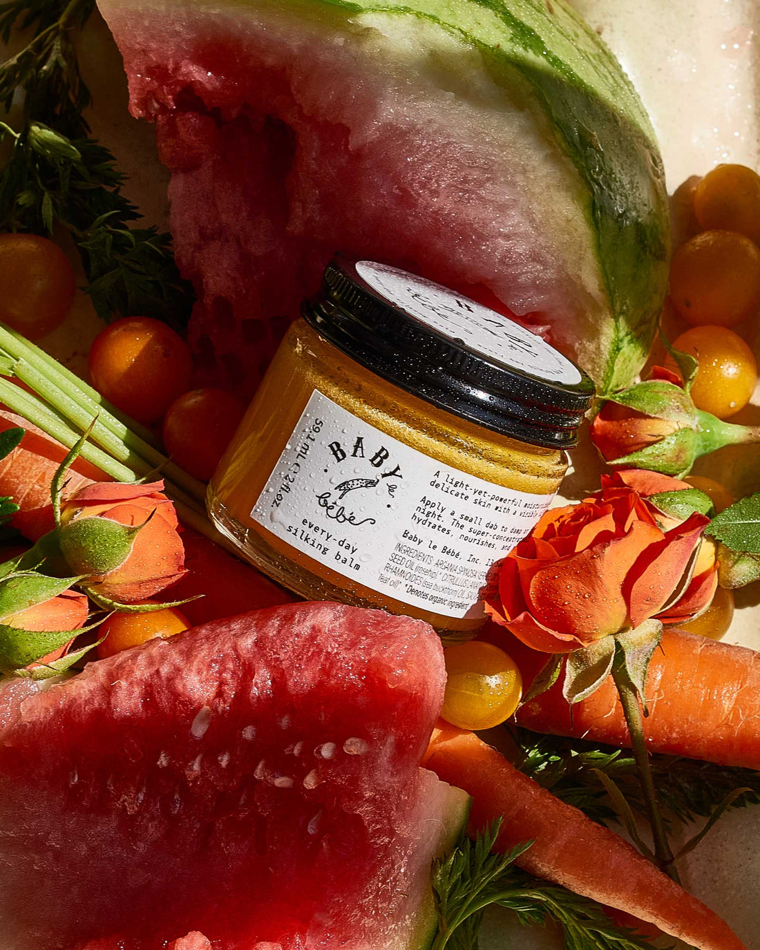 Jar of Every-Day Silking Balm in a bed of fruit