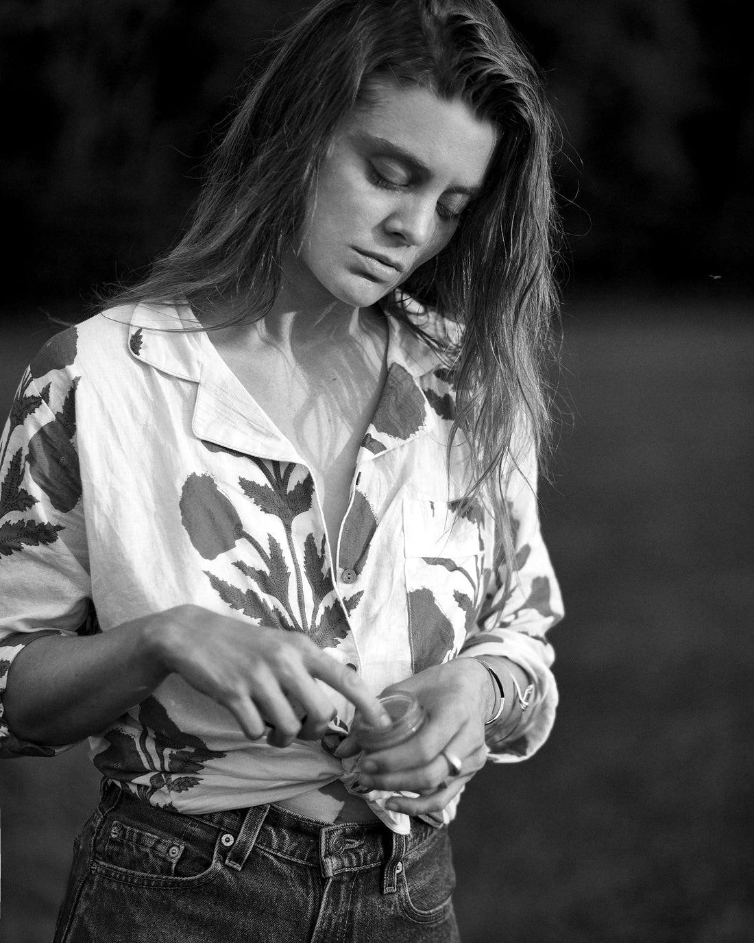 Young woman applying skin product to her face