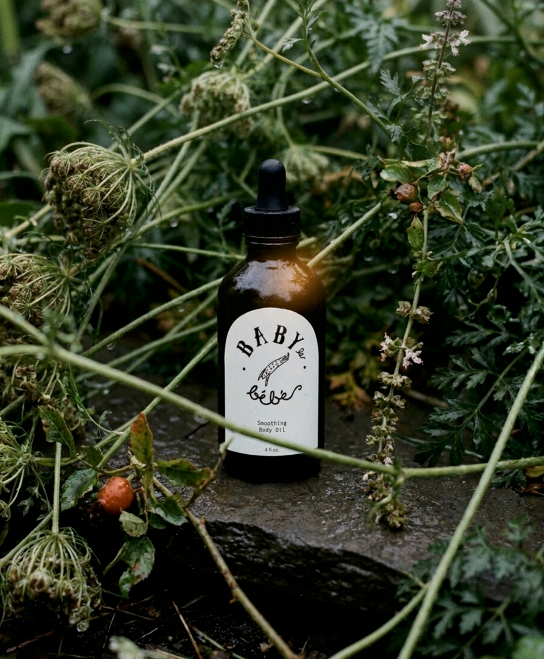 Baby le Bébé body oil bottle nestled in wild green foliage