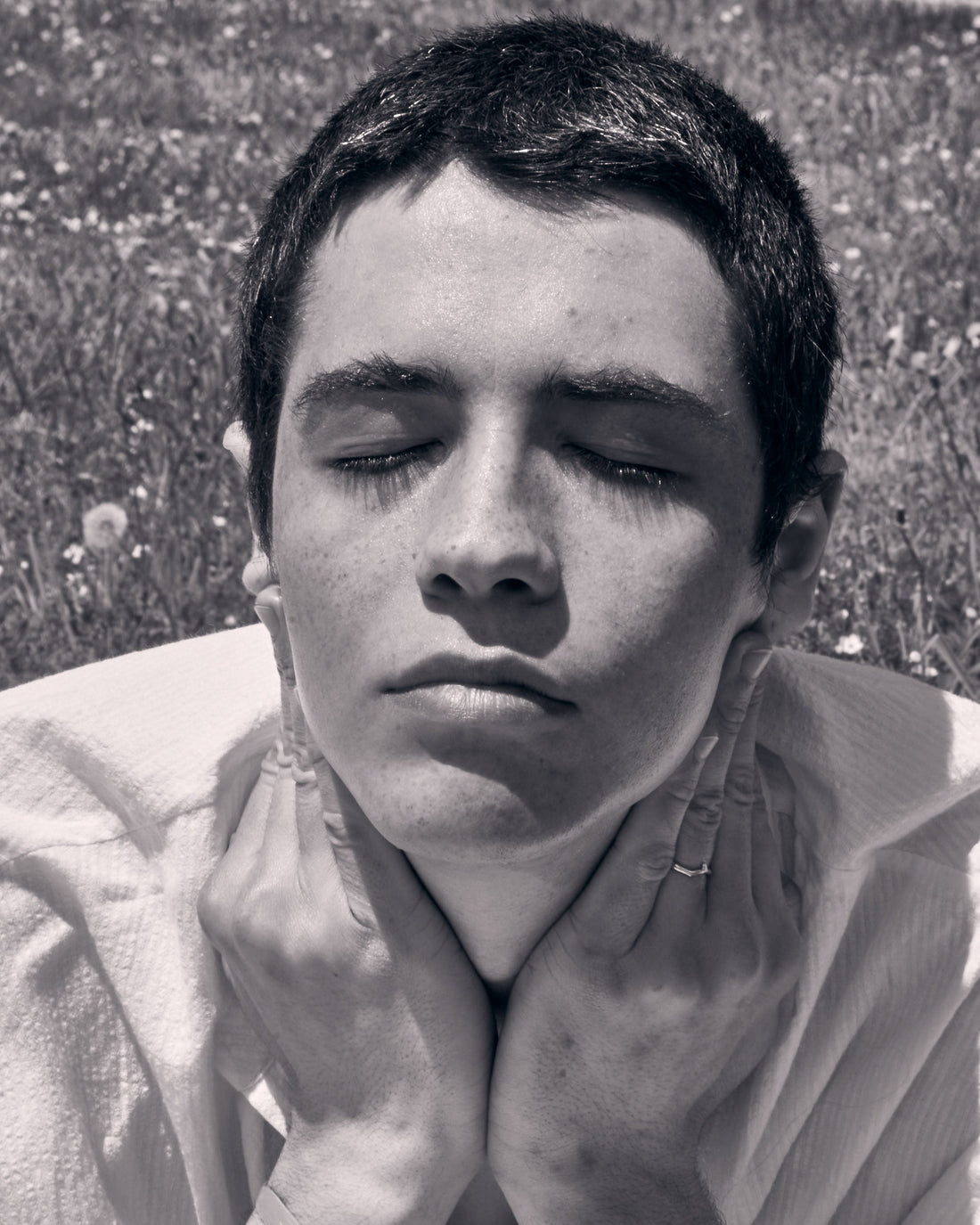 Face of a young woman showing her smooth skin in the sunlight.