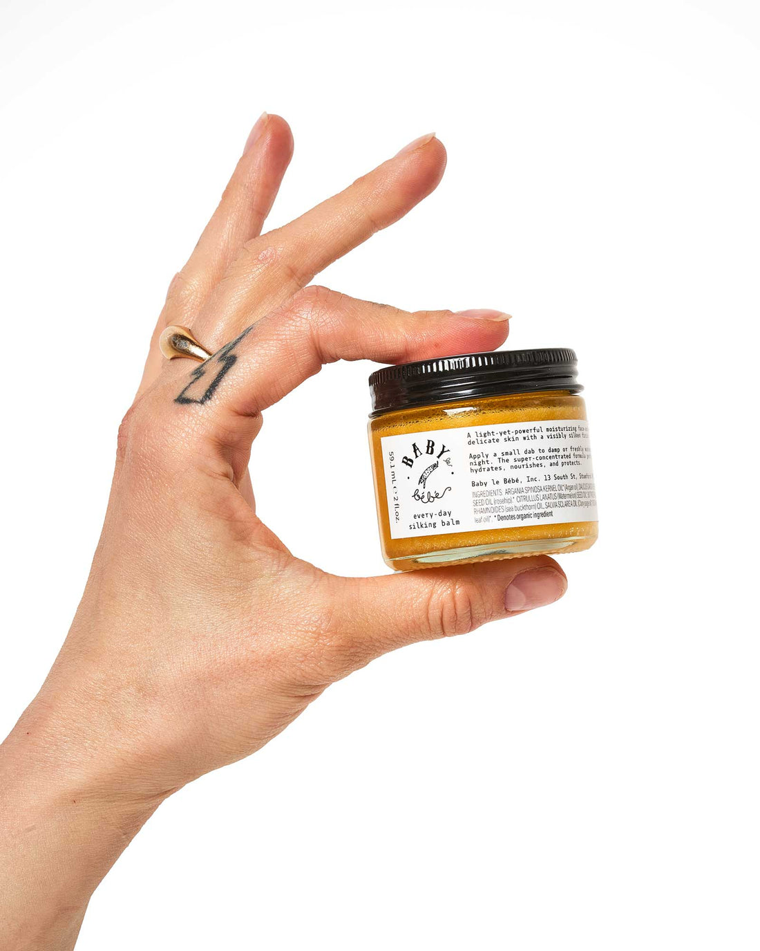 Hand holding a container if sinking balm skin balm