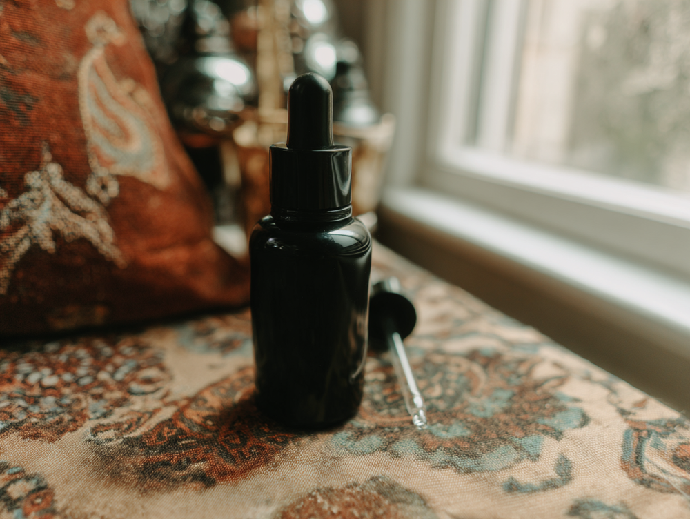 Vial of body oil and dropper 