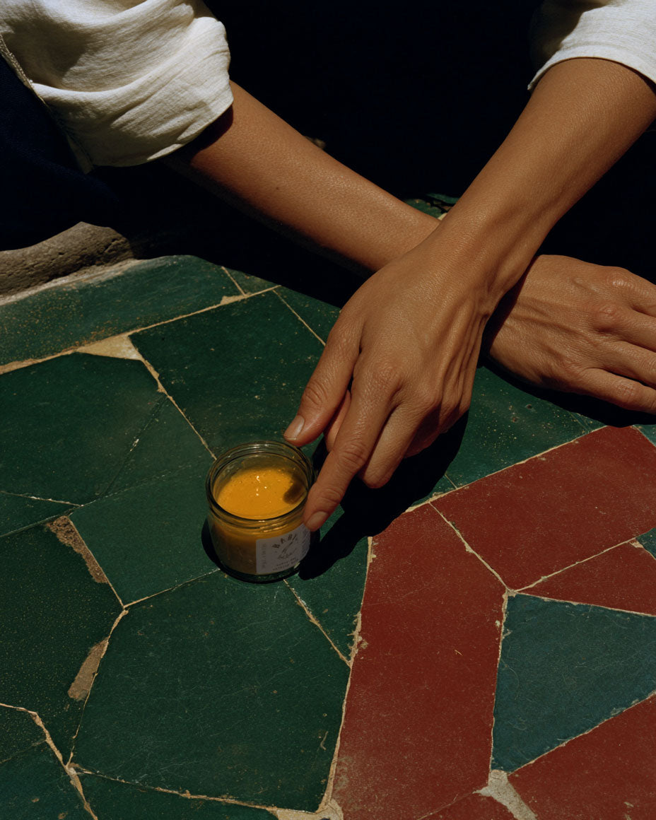 Woman's hand touching sinking balm