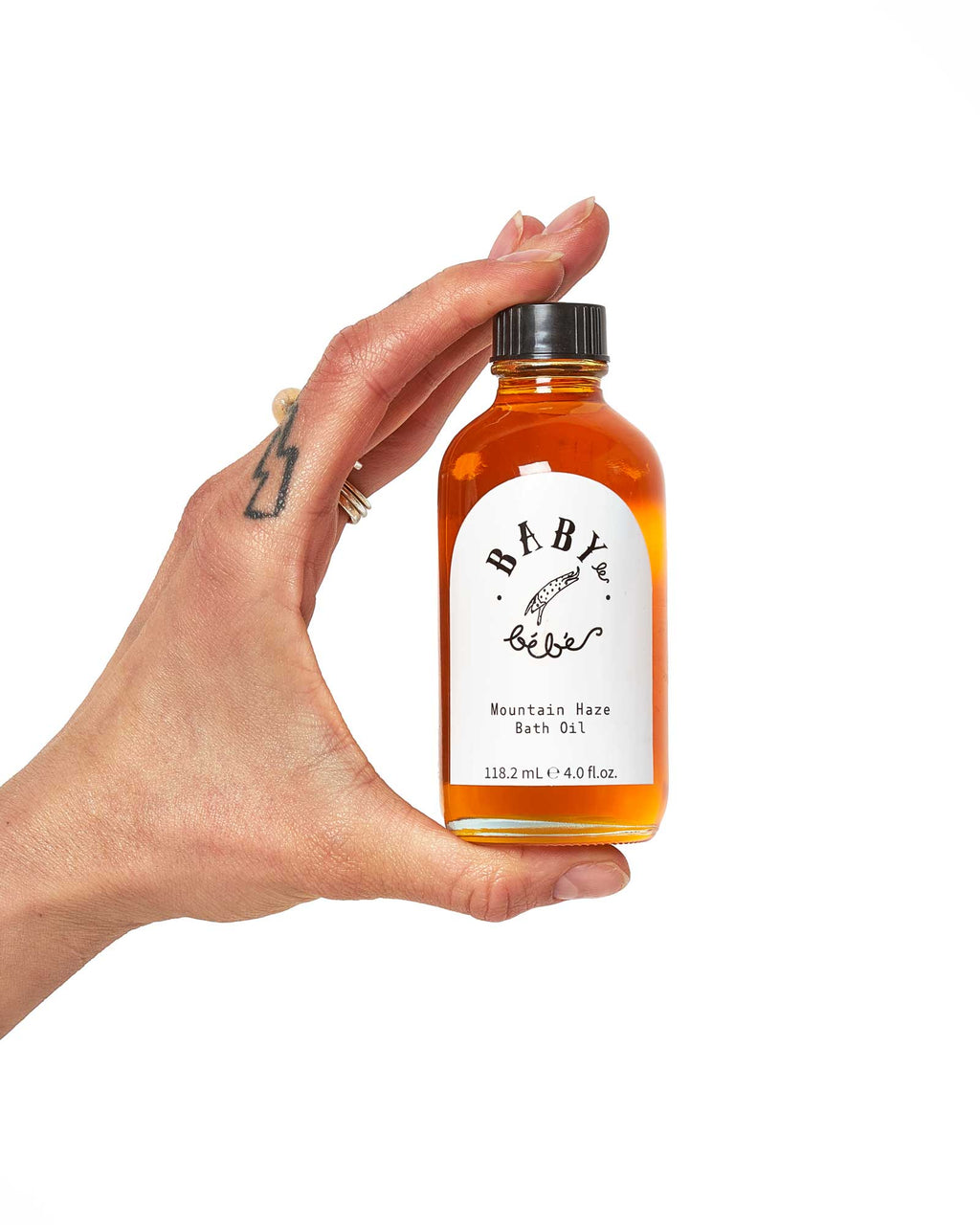 Hand holding a bottle of Mountain Haze Oil showing side view,